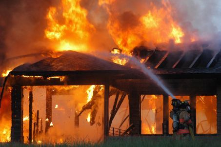Firefighters work to subdue flames at a house fire on 3003 Wood Duck Lane in Cascade Township early this morning.